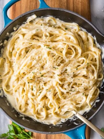 Overhead view of a skillet of fettuccine alfredo.