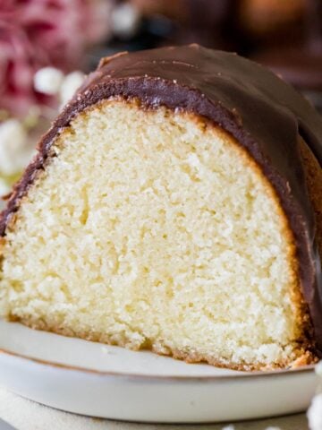 slice of hot milk cake topped with a fudgy chocolate frosting