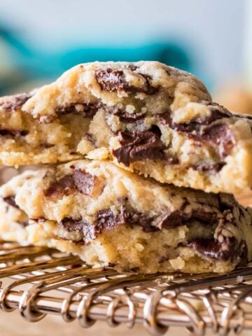 Two halves of a peanut butter chocolate chunk cookie stacked on top of each other.