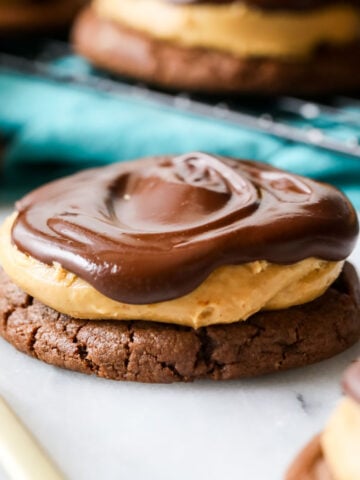 Buckeye cookie consisting of a chocolate cookie topped with peanut butter and chocolate.