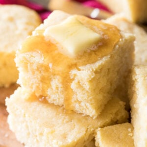 stacked squares of buttermilk cornbread topped with honey and butter