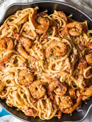 Overhead view of a skillet of cajun shrimp pasta.