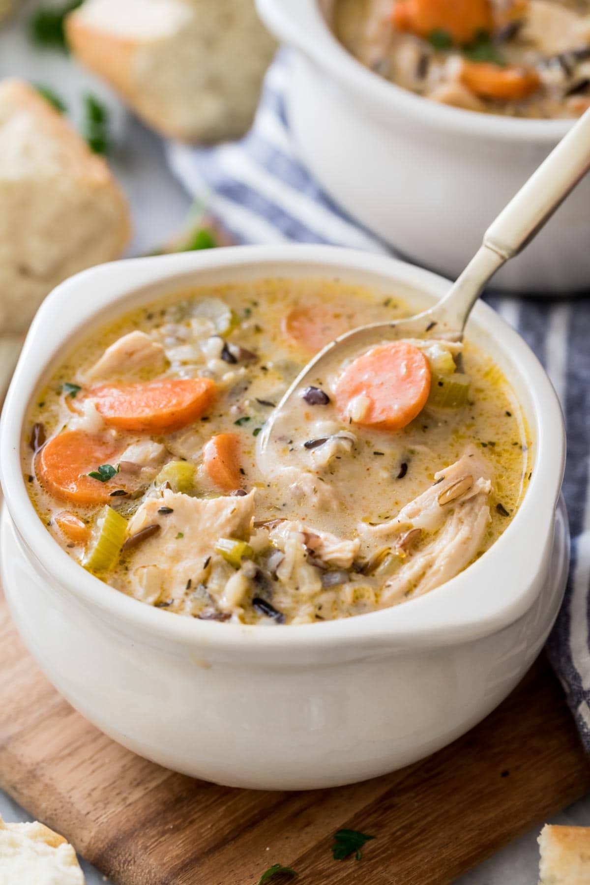 bowl of chicken and rice soup with spoon scooping a bite