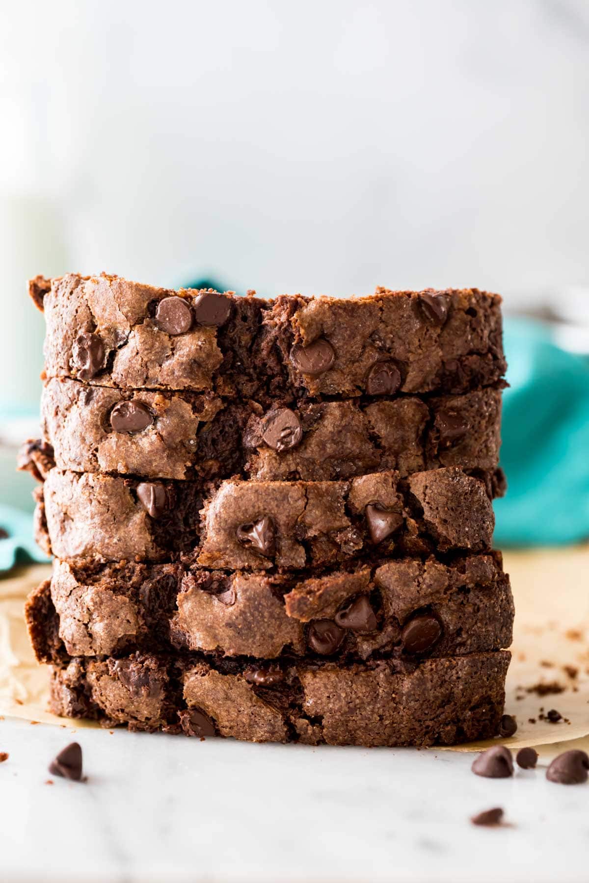 head-on view of slices of chocolate chip studded chocolate loaf bread stacked on top of each other