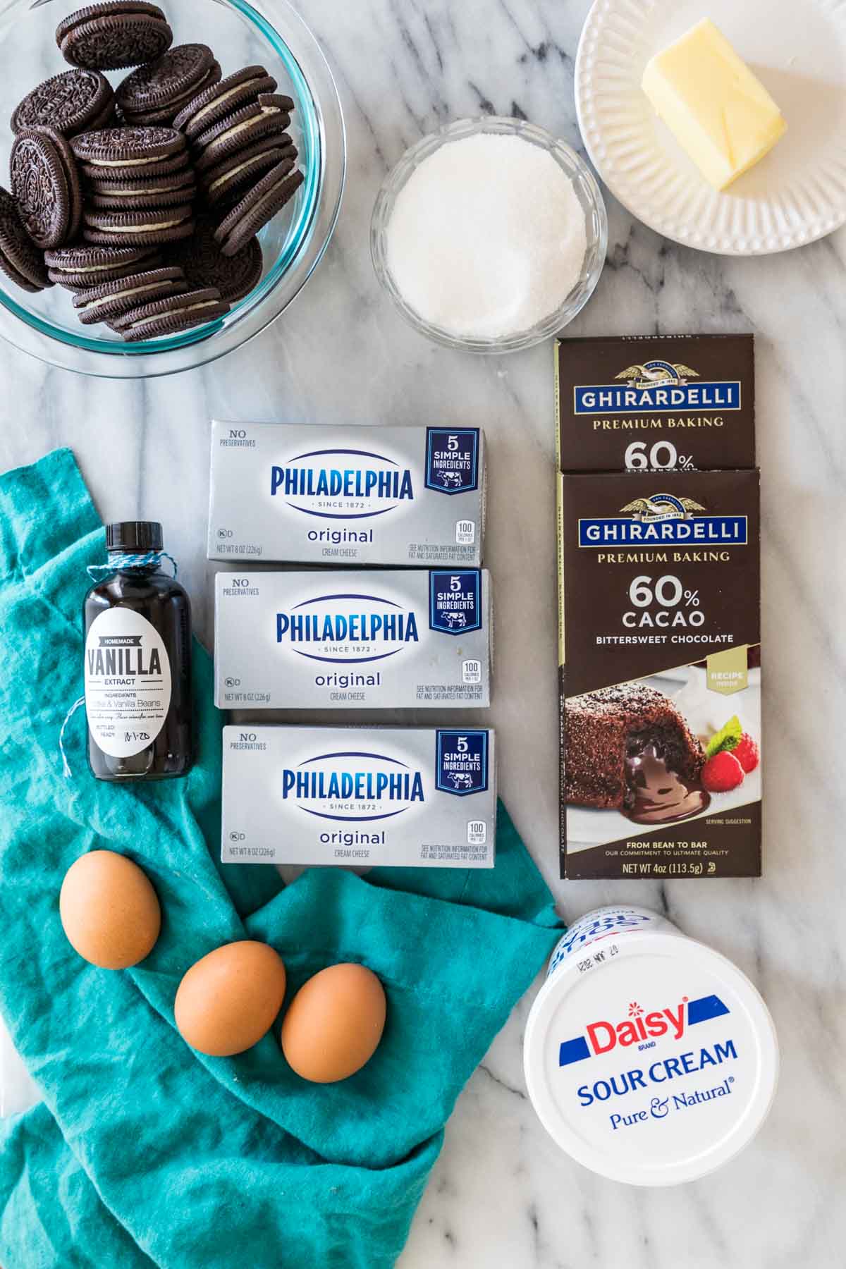 overhead view of ingredients including chocolate bars, cream cheese, oreos, and more