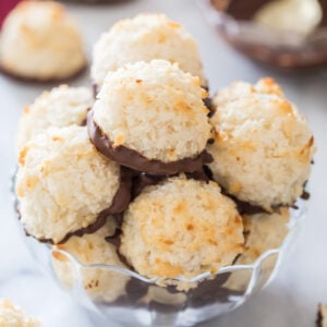 clear glass bowl full of chocolate dipped coconut macaroons