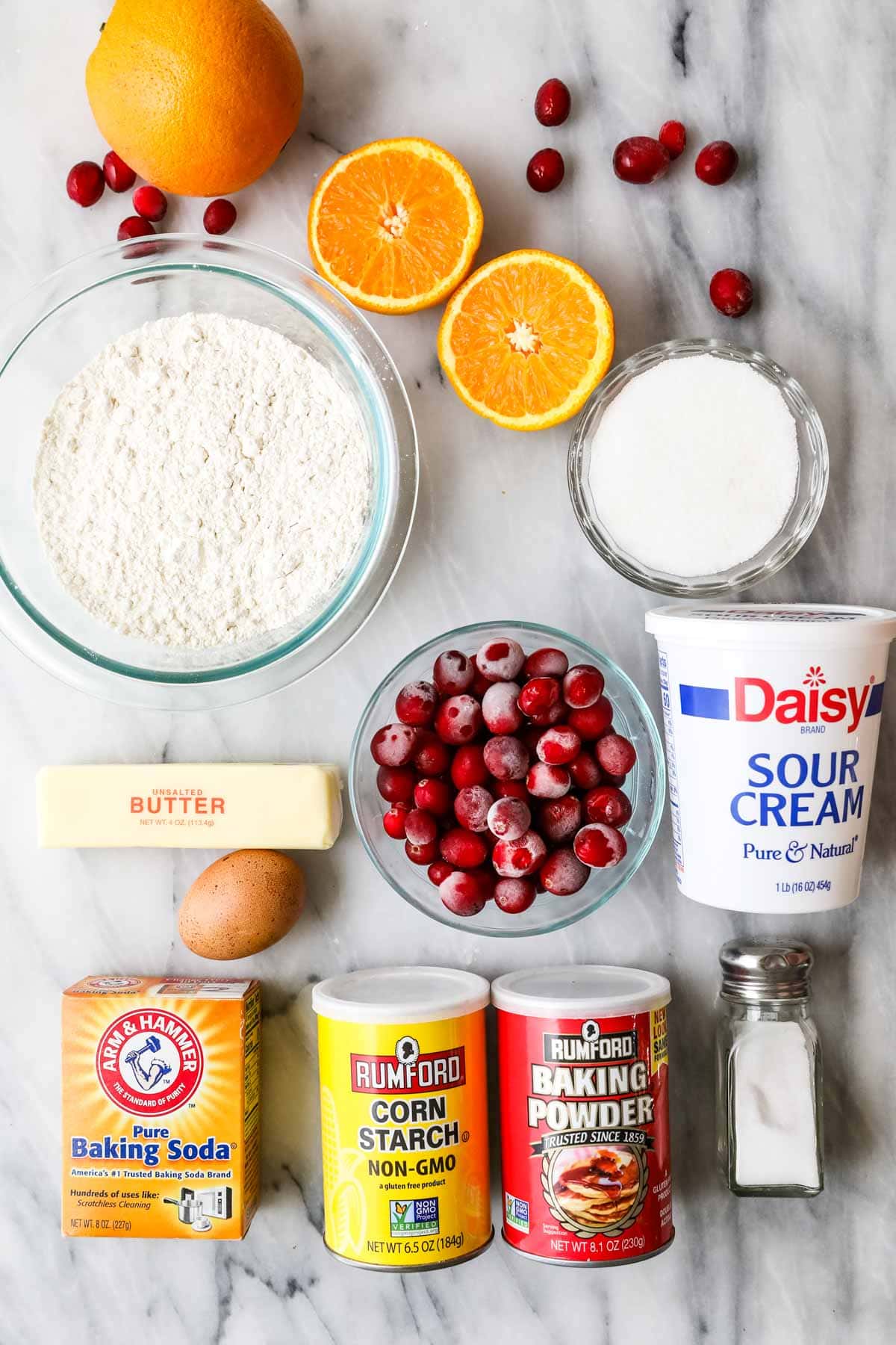 Overhead view of ingredients including oranges, sour cream, cranberries, and more.