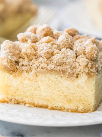 Slice of crumb cake on white plate.