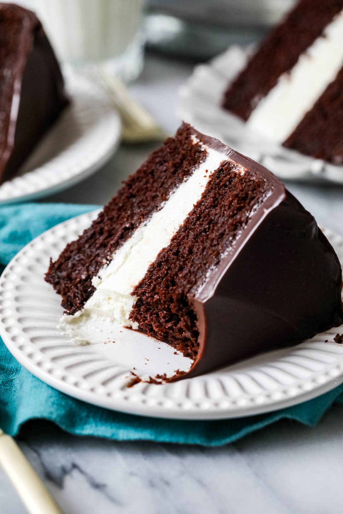 Slice of ding dong cake on a plate with one bite missing.