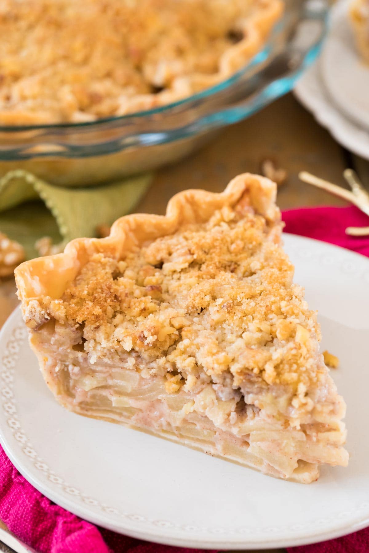 Slice of Dutch apple pie on a white plate.