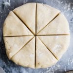 Scone dough shaped into disc, cut into 8 pieces