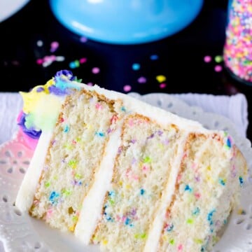 Slice of funfetti cake on a white plate