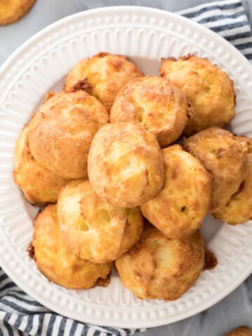 pile of cheese puffs on white plate