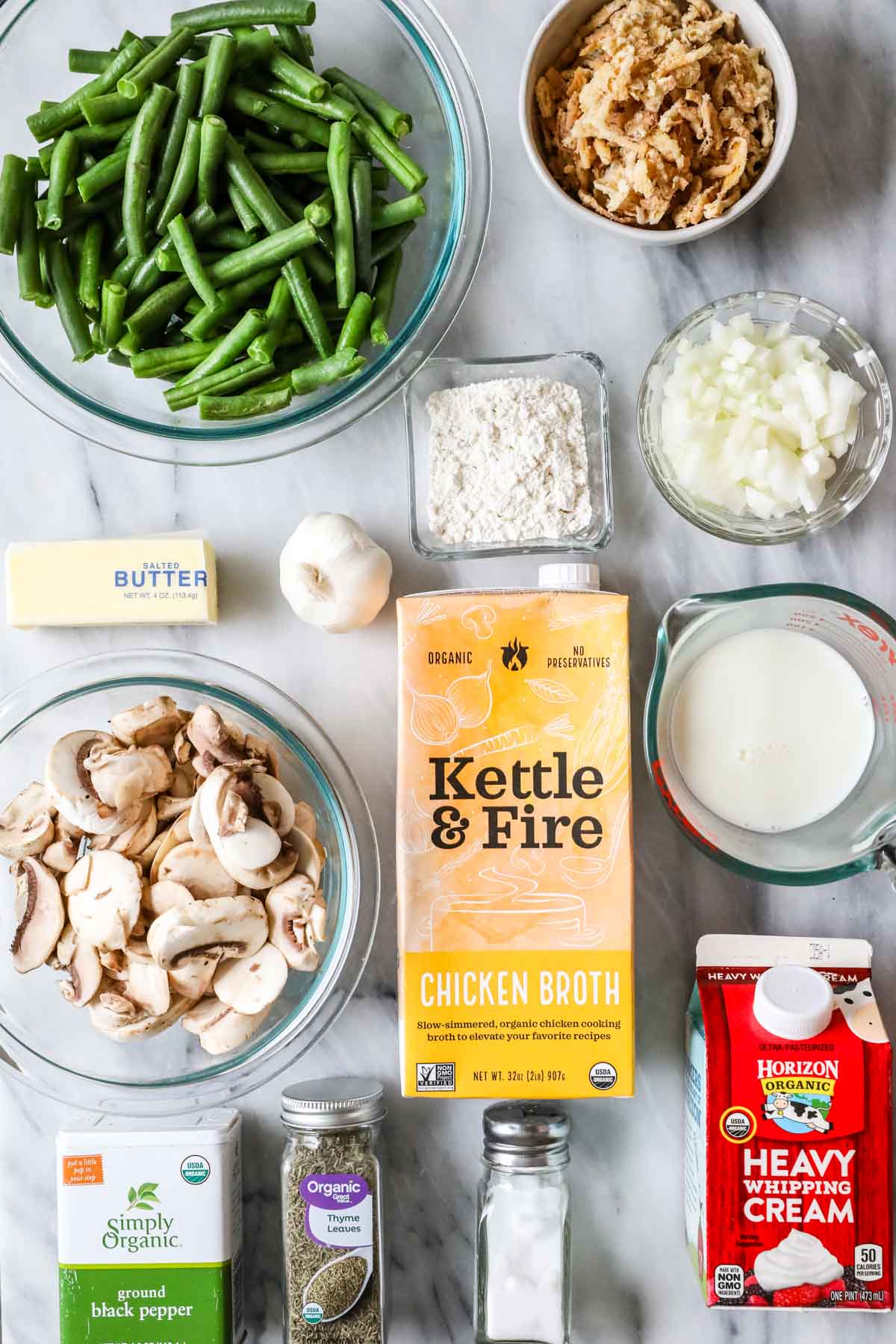 Overhead view of ingredients including green beans, mushrooms, chicken broth, cream, and more.