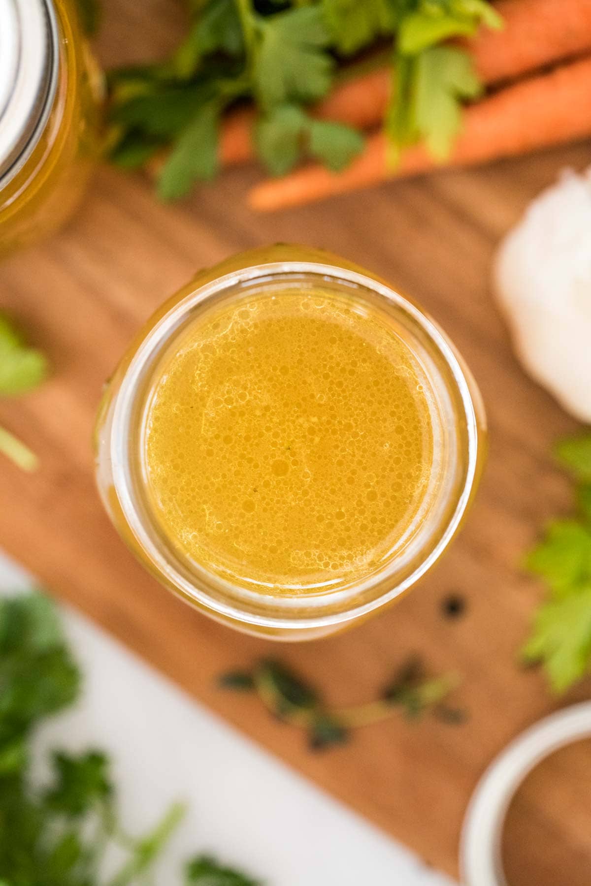 overhead view of a jar of homemade chicken stock