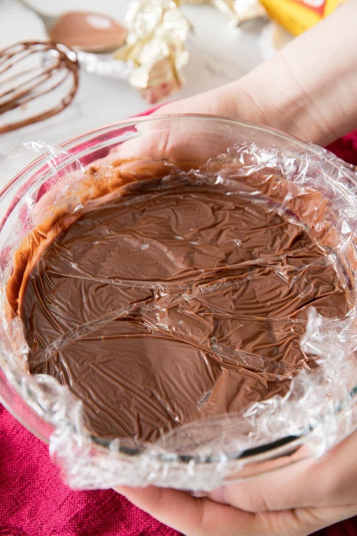 Cling wrap over the surface of homemade pudding