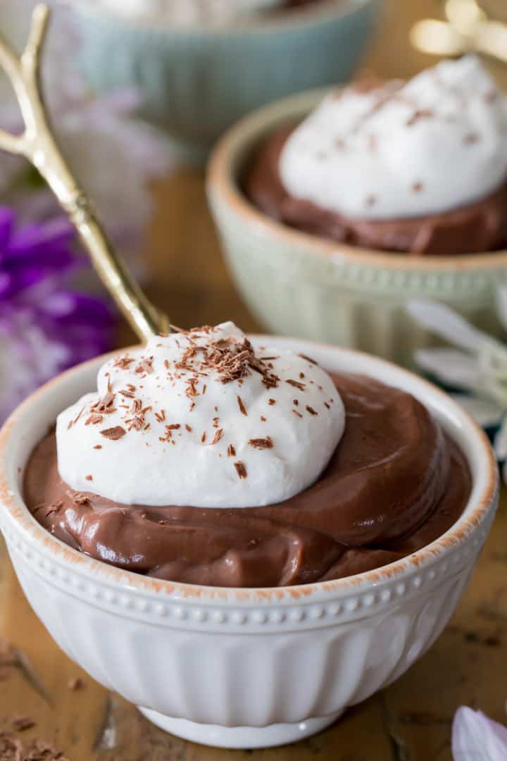 Bowl of chocolate pudding, topped with whipped cream