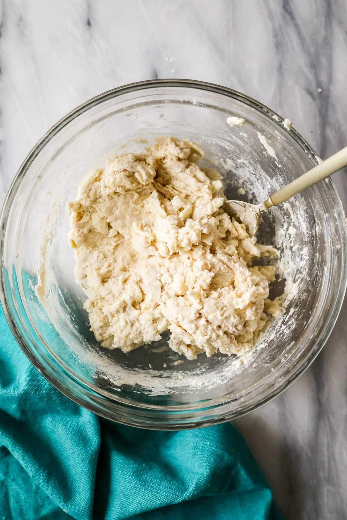 Overhead view of biscuit dough in a bowl after adding sourdough discard.