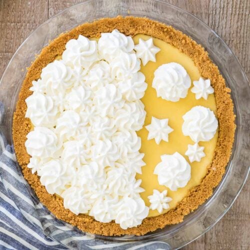 Overhead shot of a finished lemon pie decorate with homemade whipped cream.