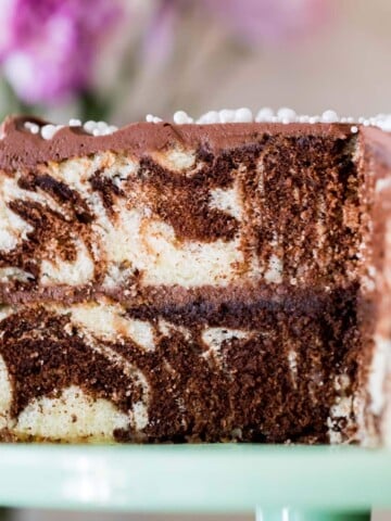 Marble cake on cake platter with slice taken out