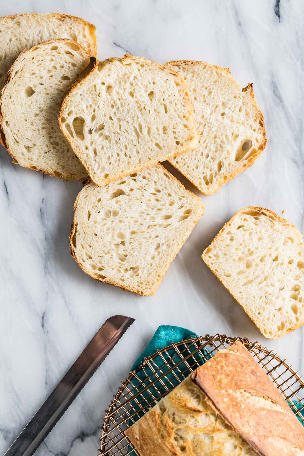 Slices of homemade bread after being cut off a loaf.