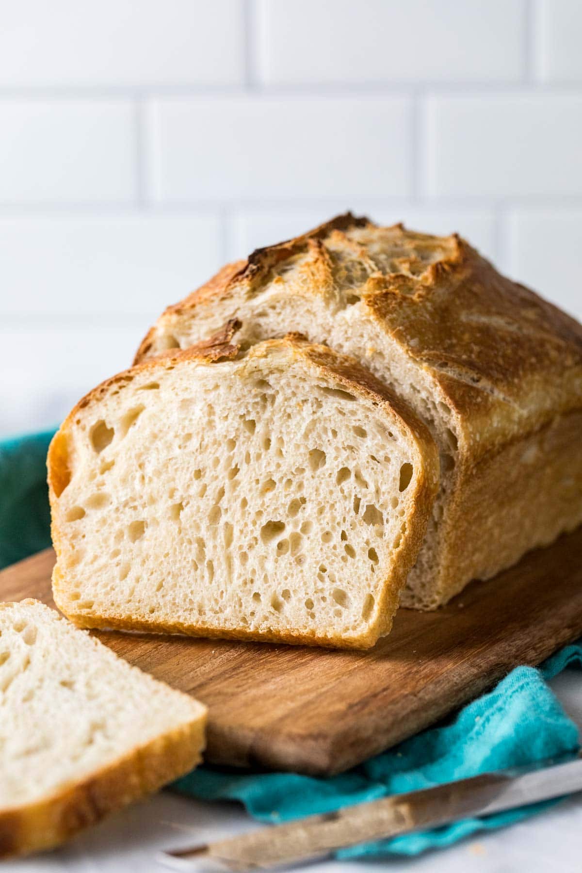 Sourdough bread loaf with a slice resting against it.