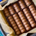 Overhead of oreo mint candy bars placed into brownie batter pan