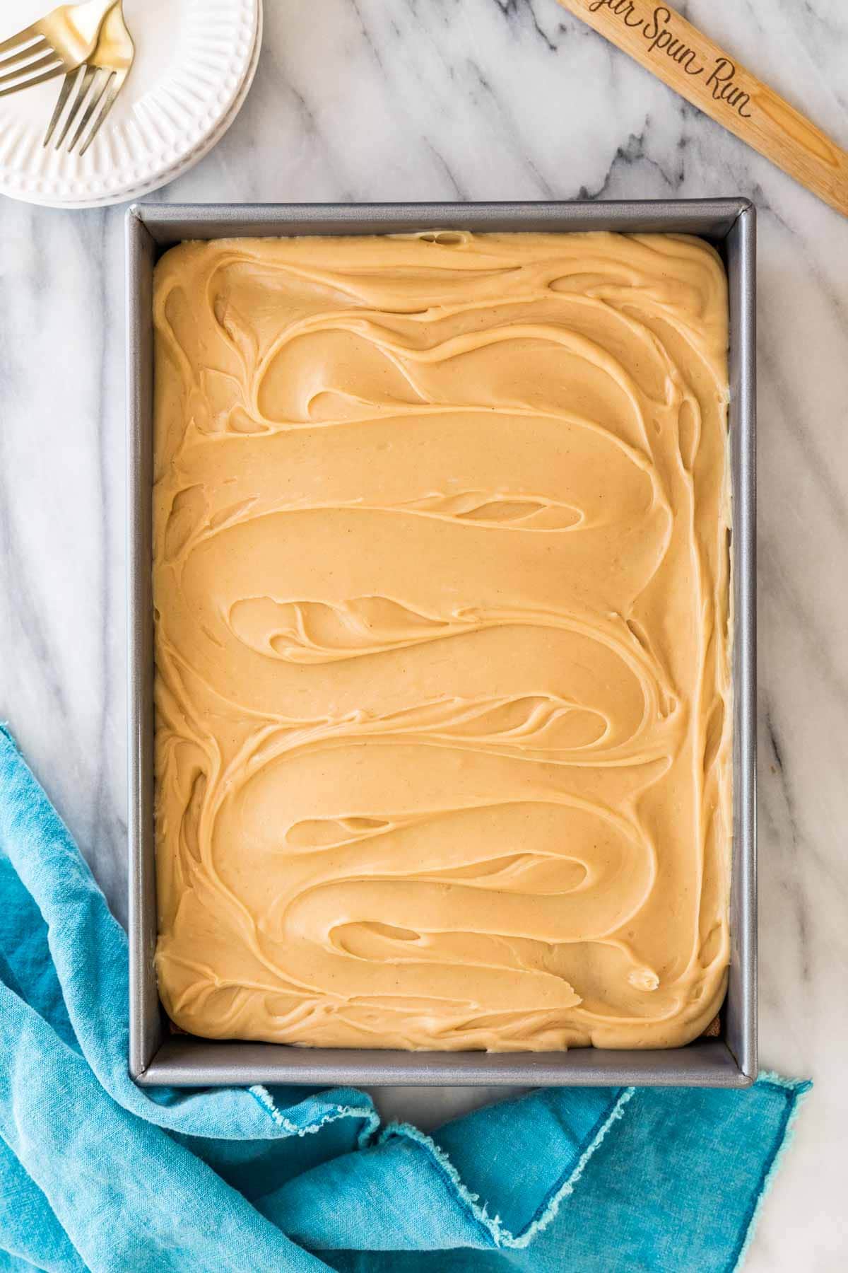 Overhead view of a sheet cake that's been frosted with a fudgy peanut butter frosting.