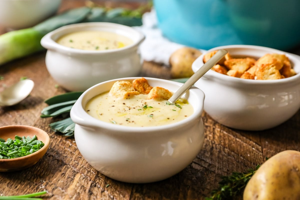 Crocks of soup topped with croutons, chives, and fresh thyme.