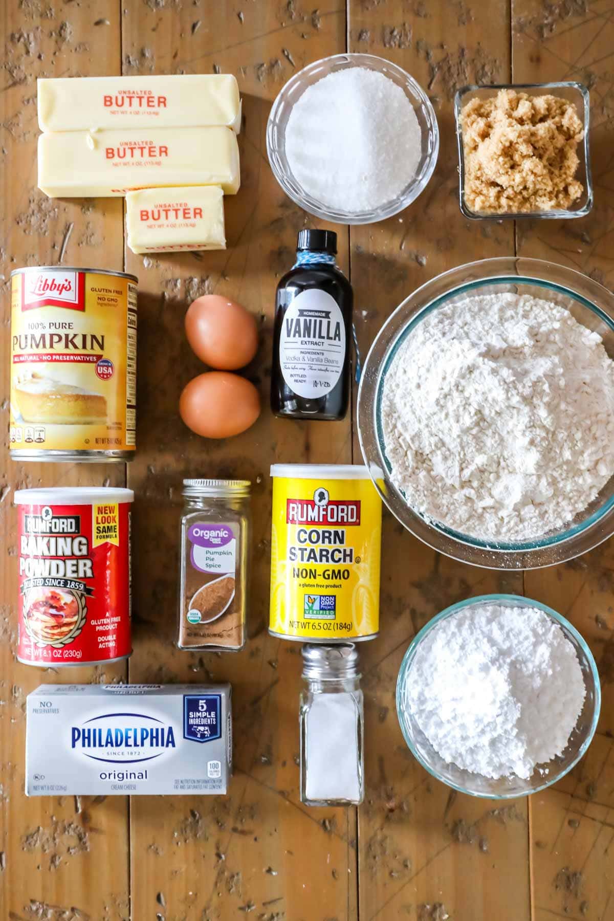 Overhead view of ingredients including butter, pumpkin, cream cheese, cornstarch, and more.