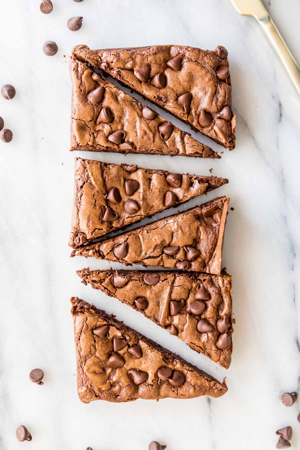 Overhead view of brownies cut into triangles after baking in a bread pan.