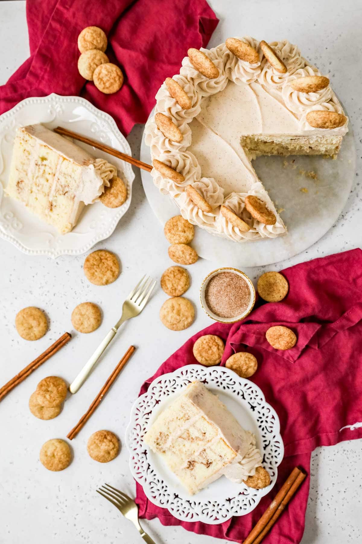 Overhead view of a snickerdoodle cake that's been cut and served into two slices.