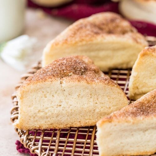 Cinnamon sugar dusted snickerdoodle scones on gold cooling rack