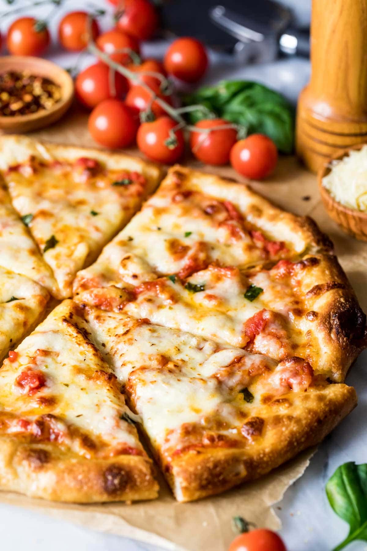 Pizza made from a sourdough pizza crust that has been cut into slices for serving.