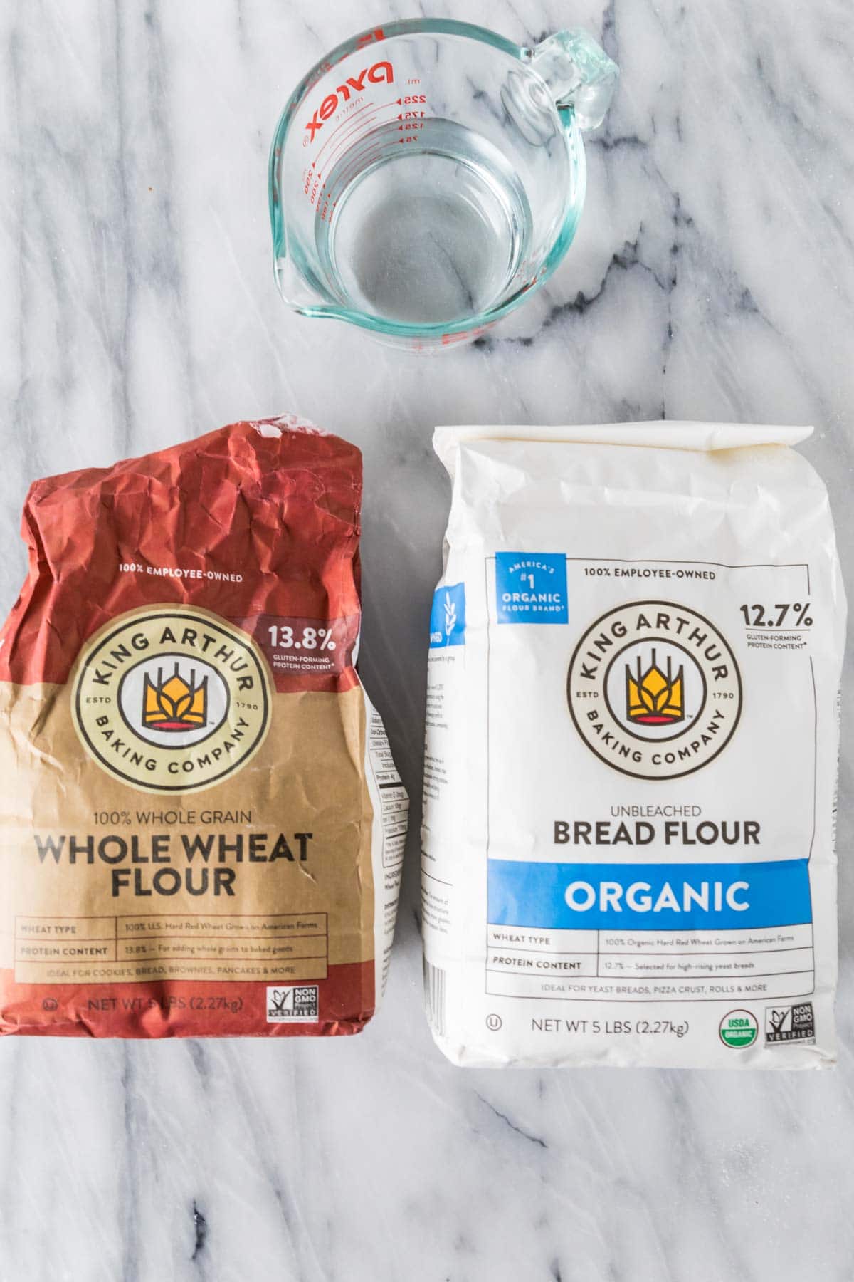 Overhead view of ingredients including water, whole wheat flour, and organic bread flour.