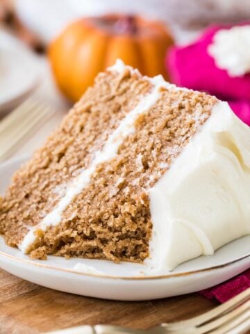 Two-layer slice of spice cake missing one bite.